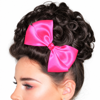 Camelia Rose plain pink satin bow shown close up on a model against a white background